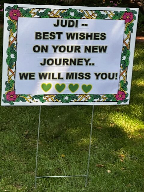 A yard sign says it all, ‘Judi - We will Miss You!’