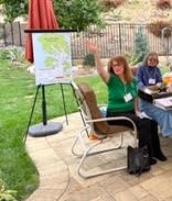 Jean shows off our new Plant-A-Tree donation chart