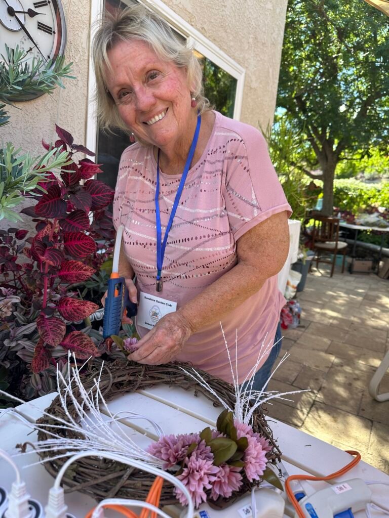 Debra H. works on her wreath
