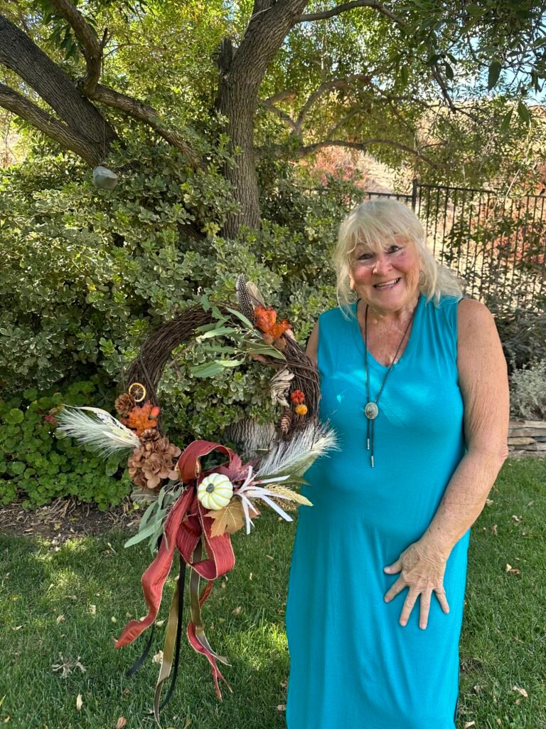 Susan displays her completed wreath